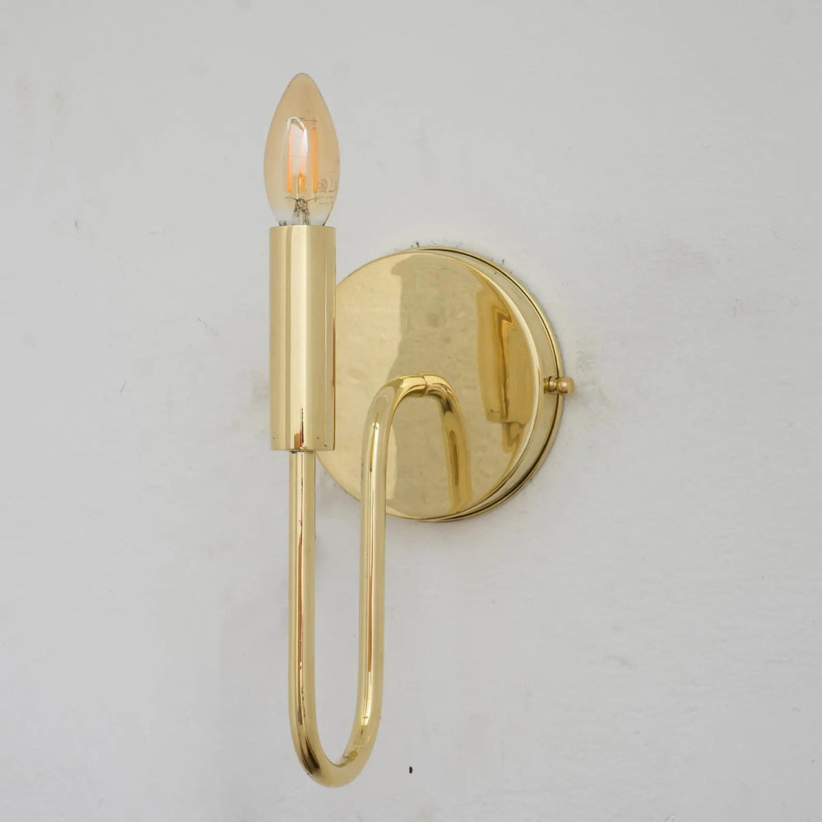 Unlacquered brass wall sconce shown without the optional linen shade