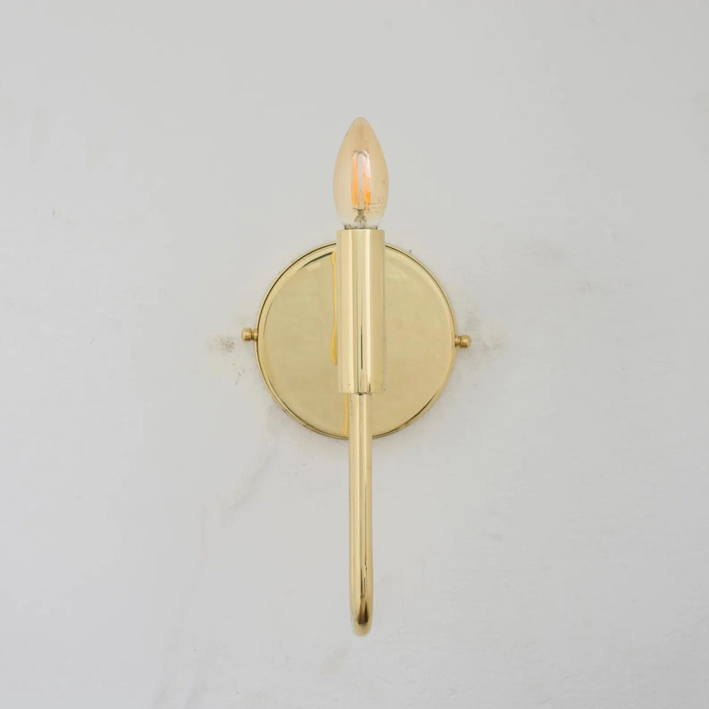 Front view of the bare brass wall sconce and curved arm