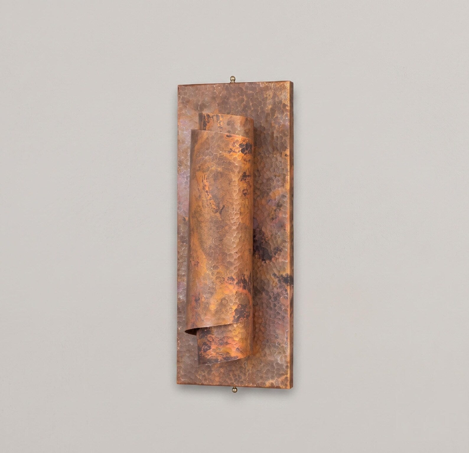 Full view of the antique hammered copper wall sconce with rectangular backplate
