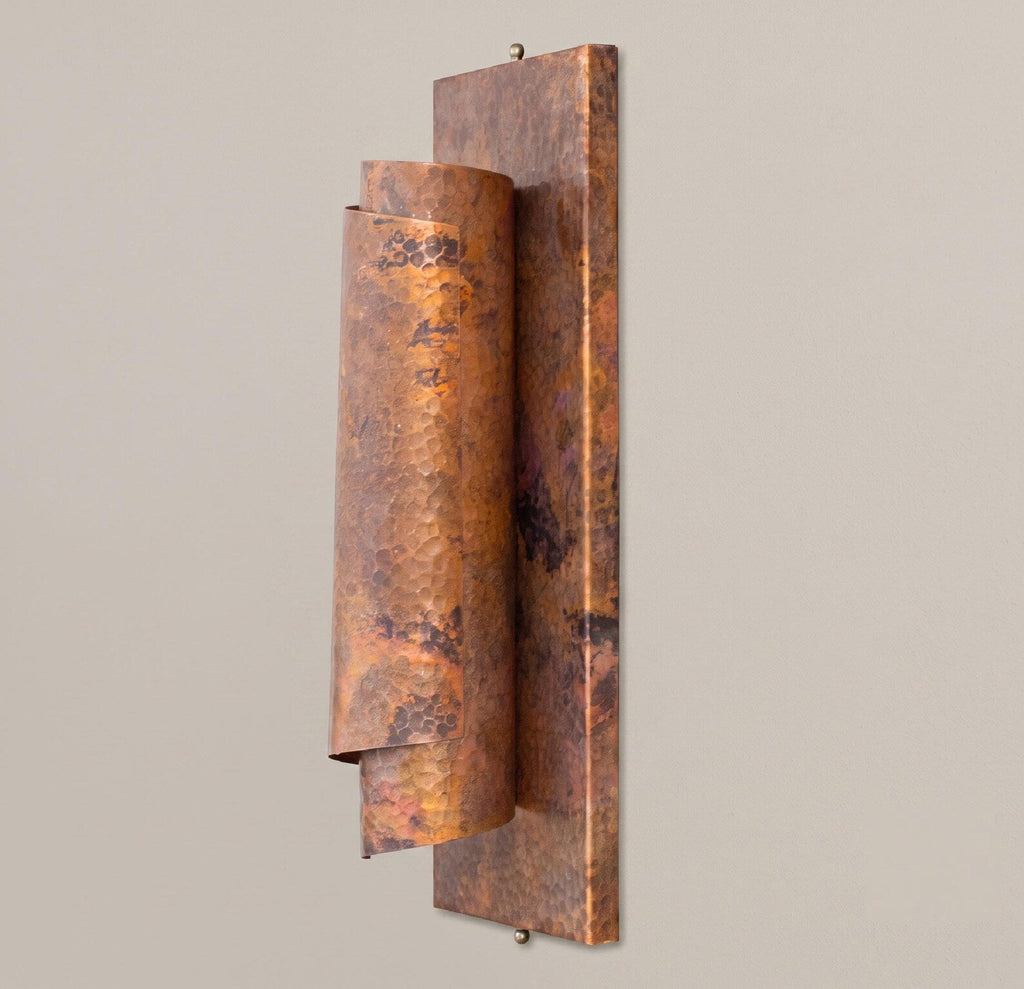 Angled view of the curved copper reflector and rectangular mounting plate