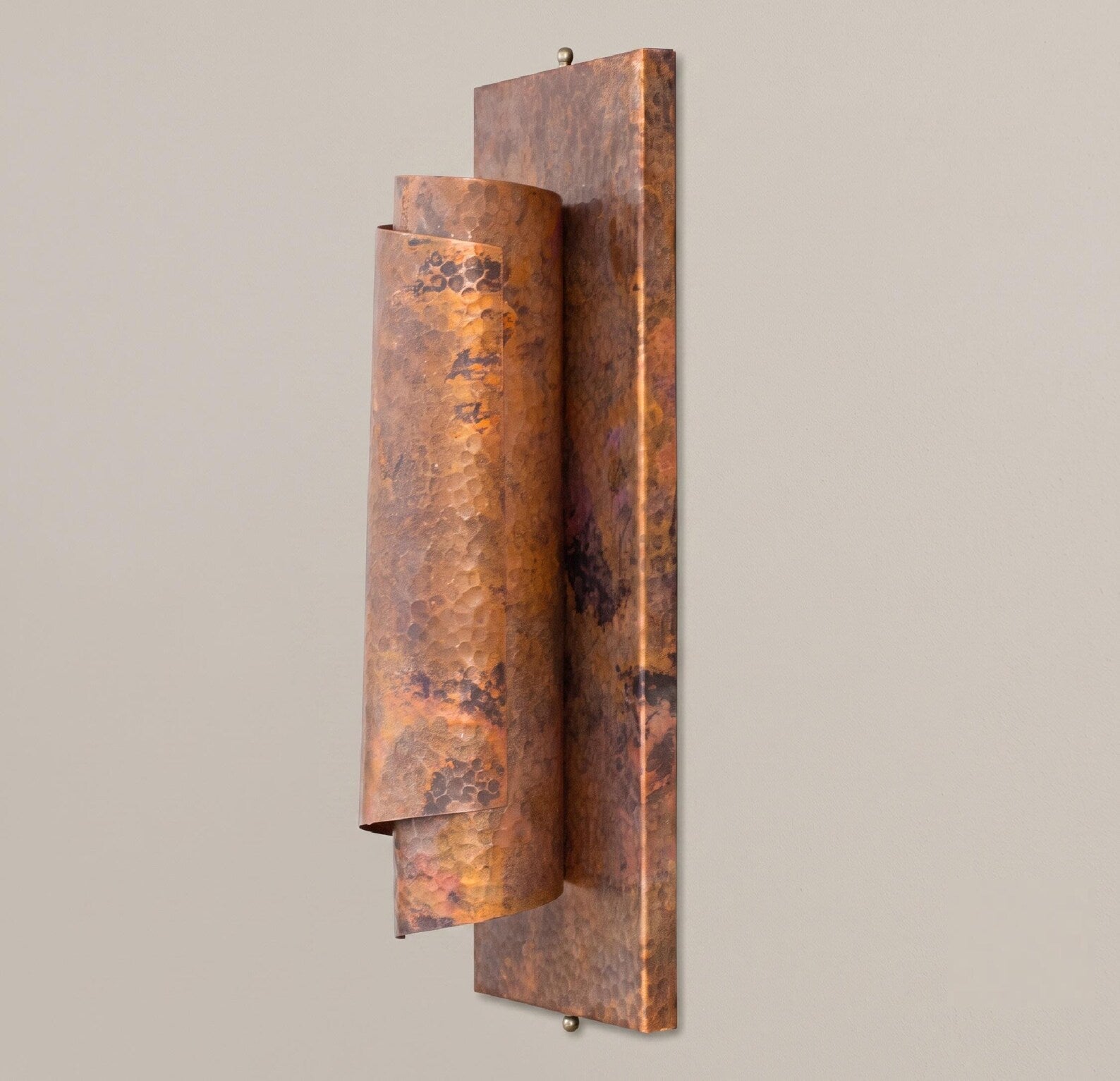 Angled view of the curved copper reflector and rectangular mounting plate