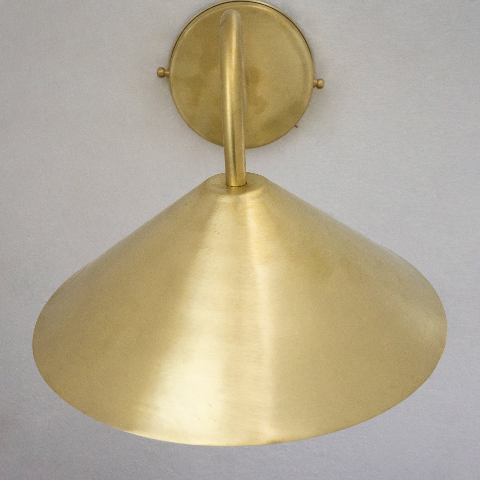 Close-up of the hand-brushed brass cone shade