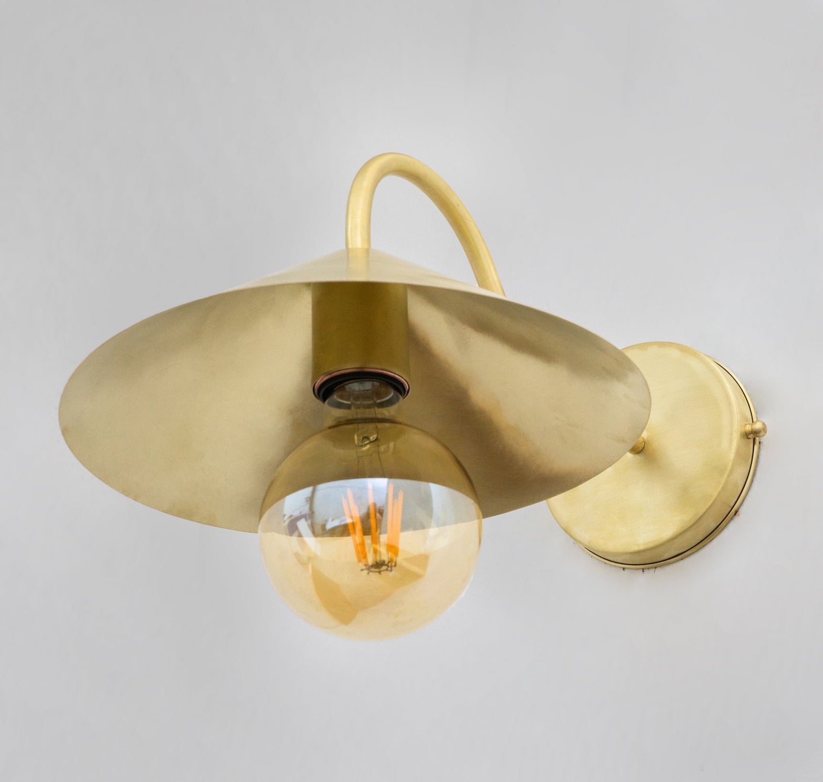 Underside view of the brass cone shade and bulb socket