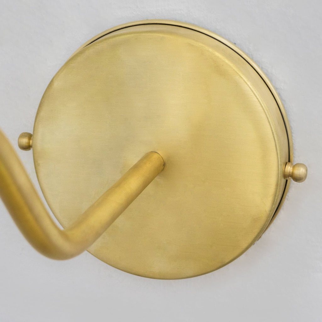 Close-up of the brass wall backplate and arm connection