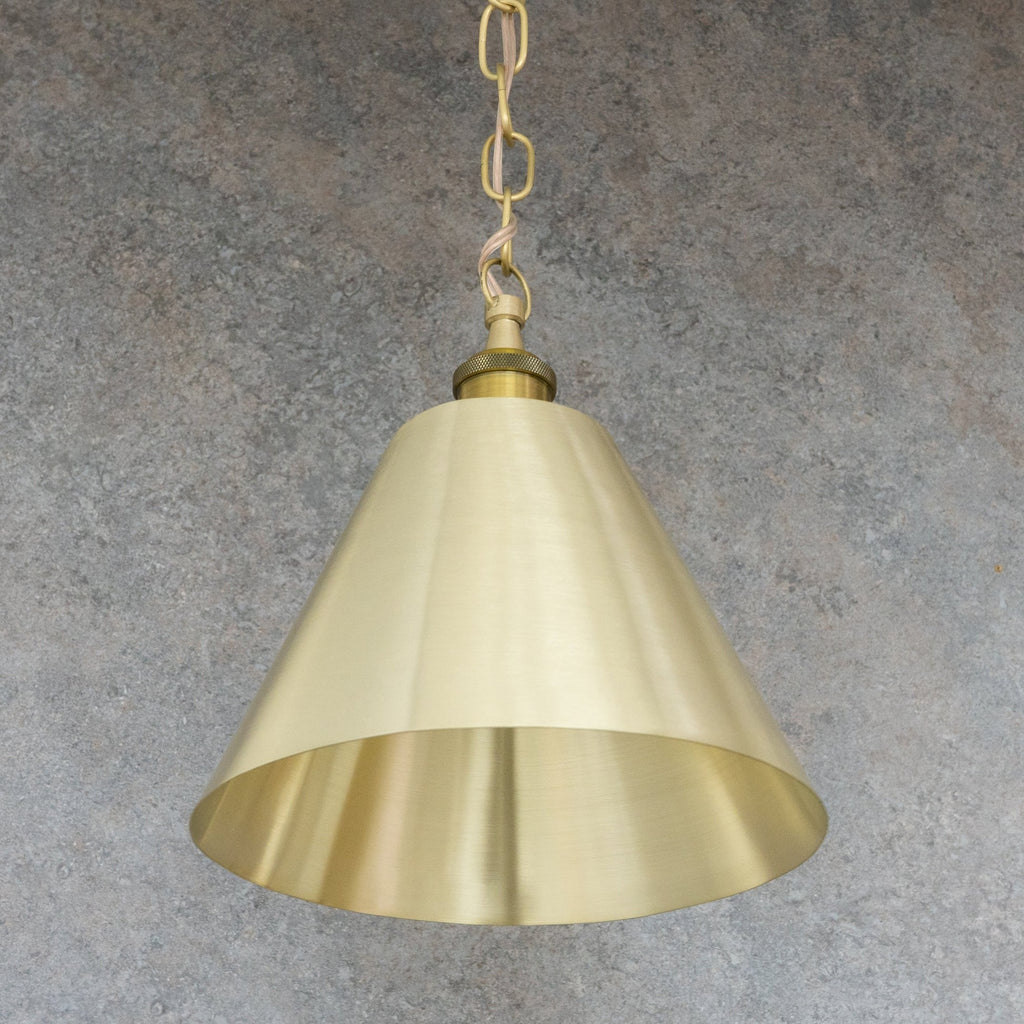 Full view of the satin brushed brass conical pendant shade