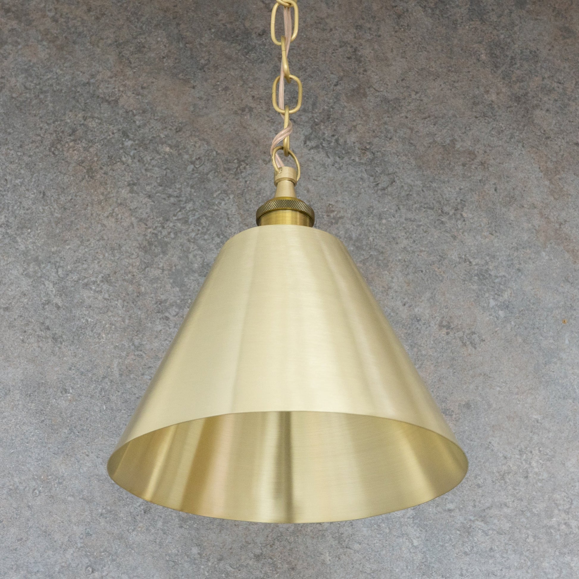 Full view of the satin brushed brass conical pendant shade