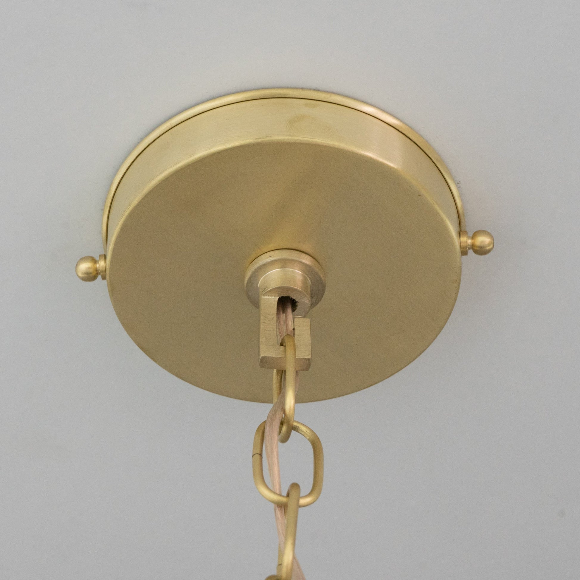Brass ceiling canopy and suspension connection viewed from below