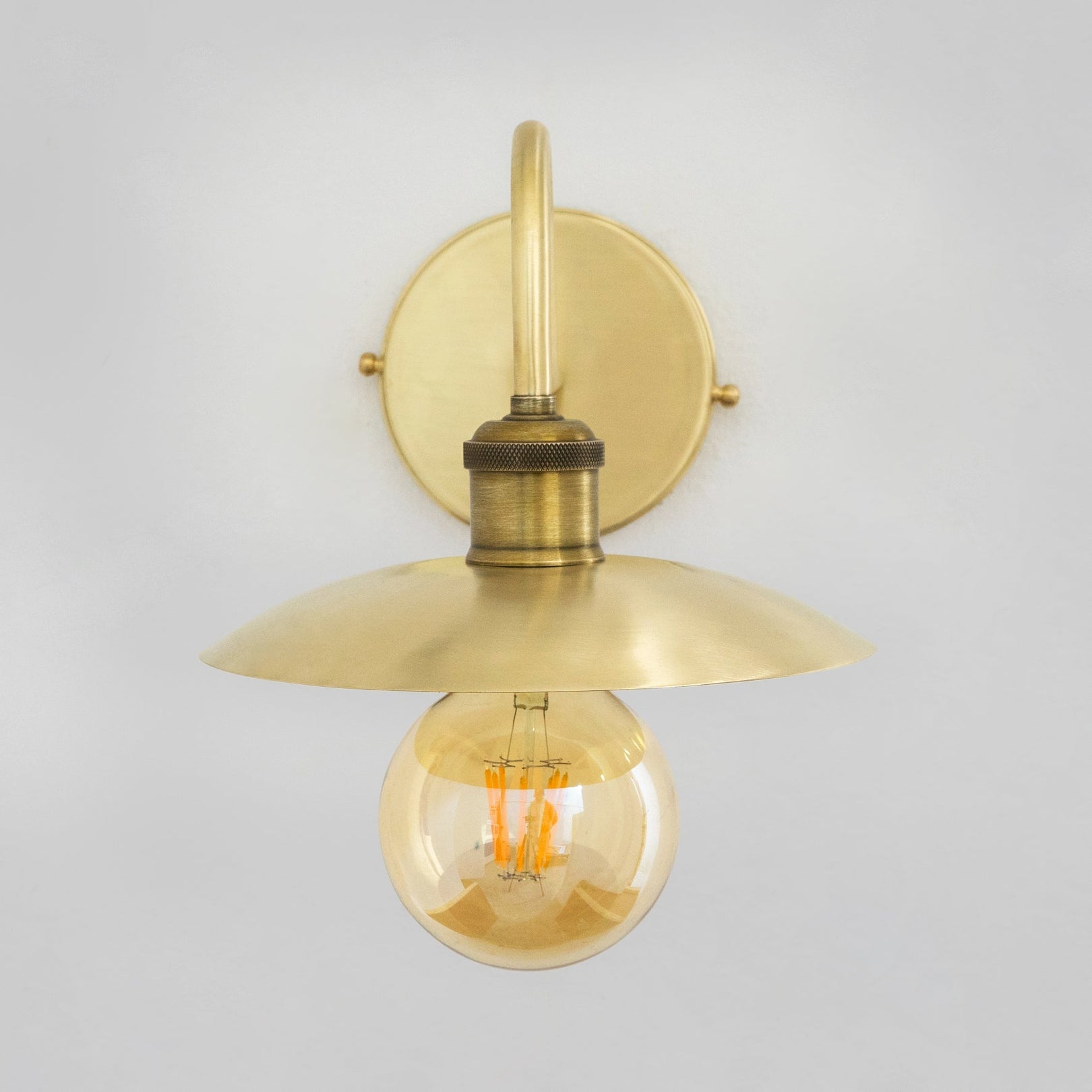 Front view of the brushed brass wall lamp