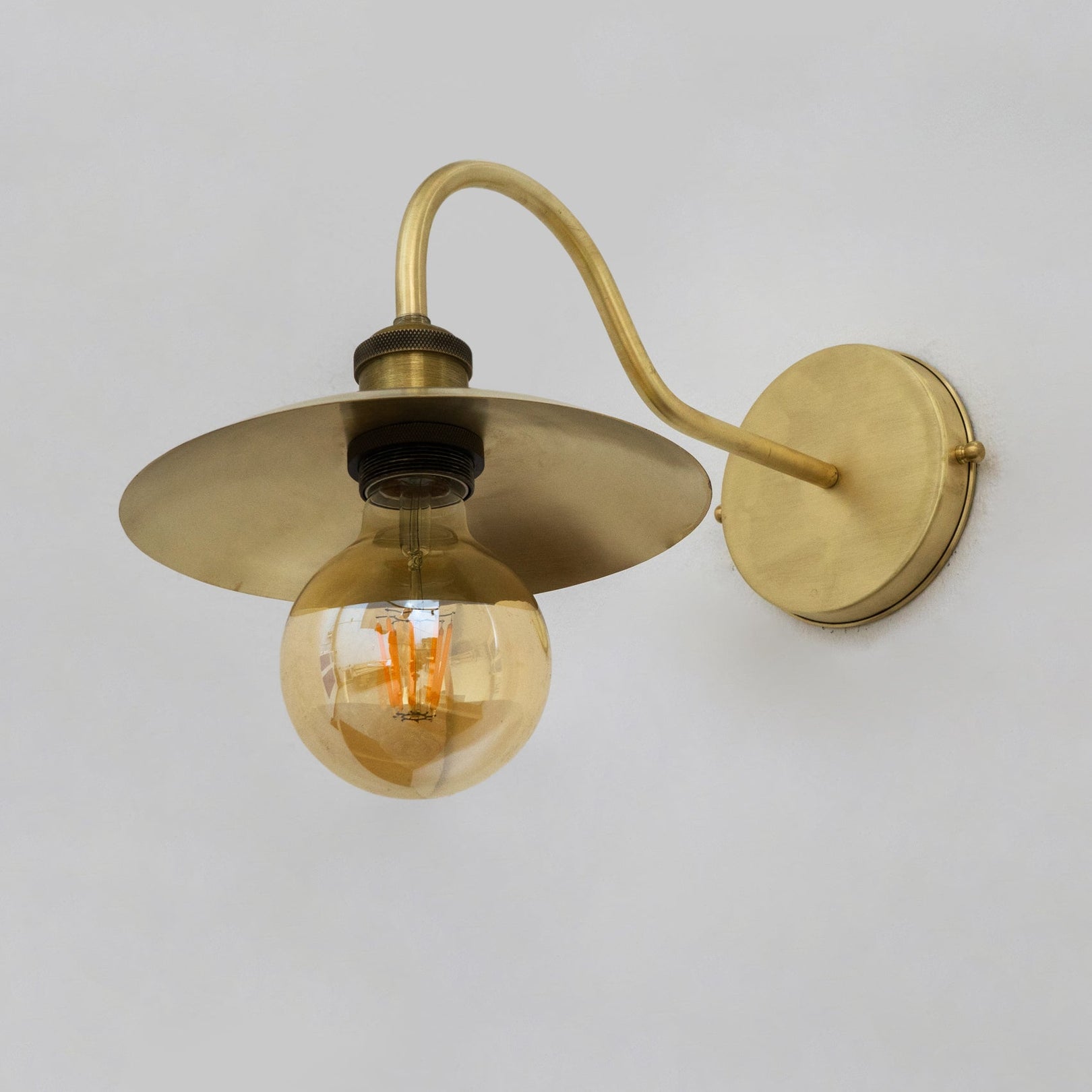 Underside of the brass wall sconce showing the socket
