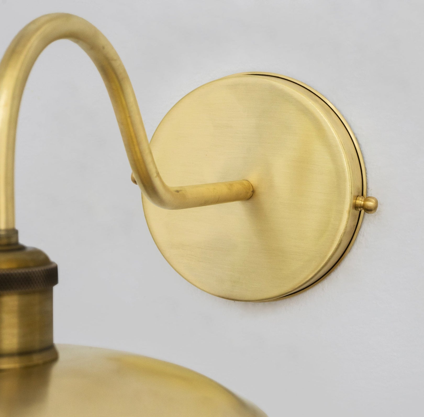 Close-up of the brass wall backplate and arm