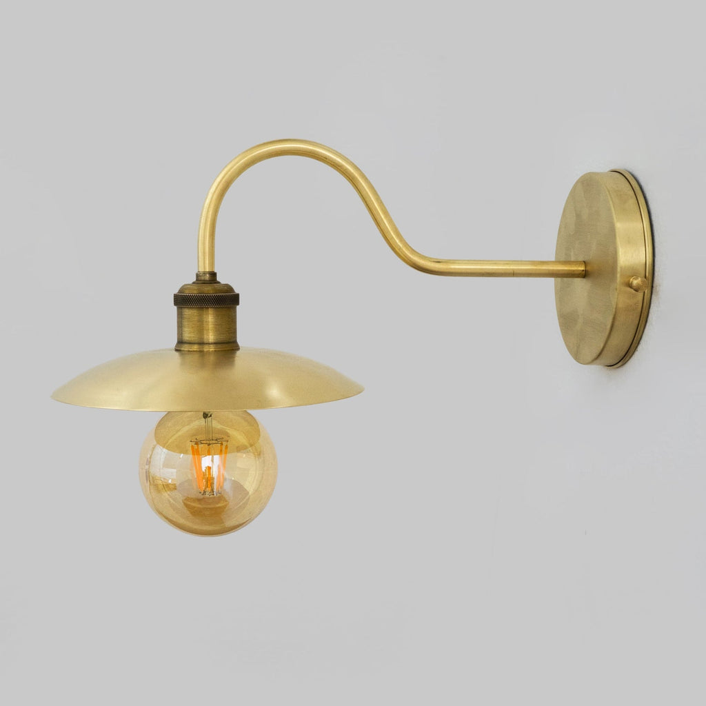 Side profile of the brass wall arm and shallow shade
