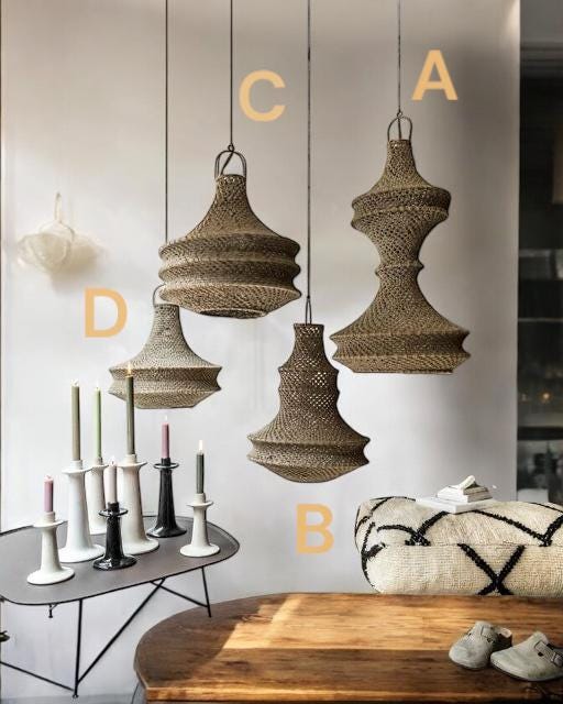 Four hanging pendant lights made of woven brown natural fiber, labeled A, B, C, and D. Each light features a unique,…