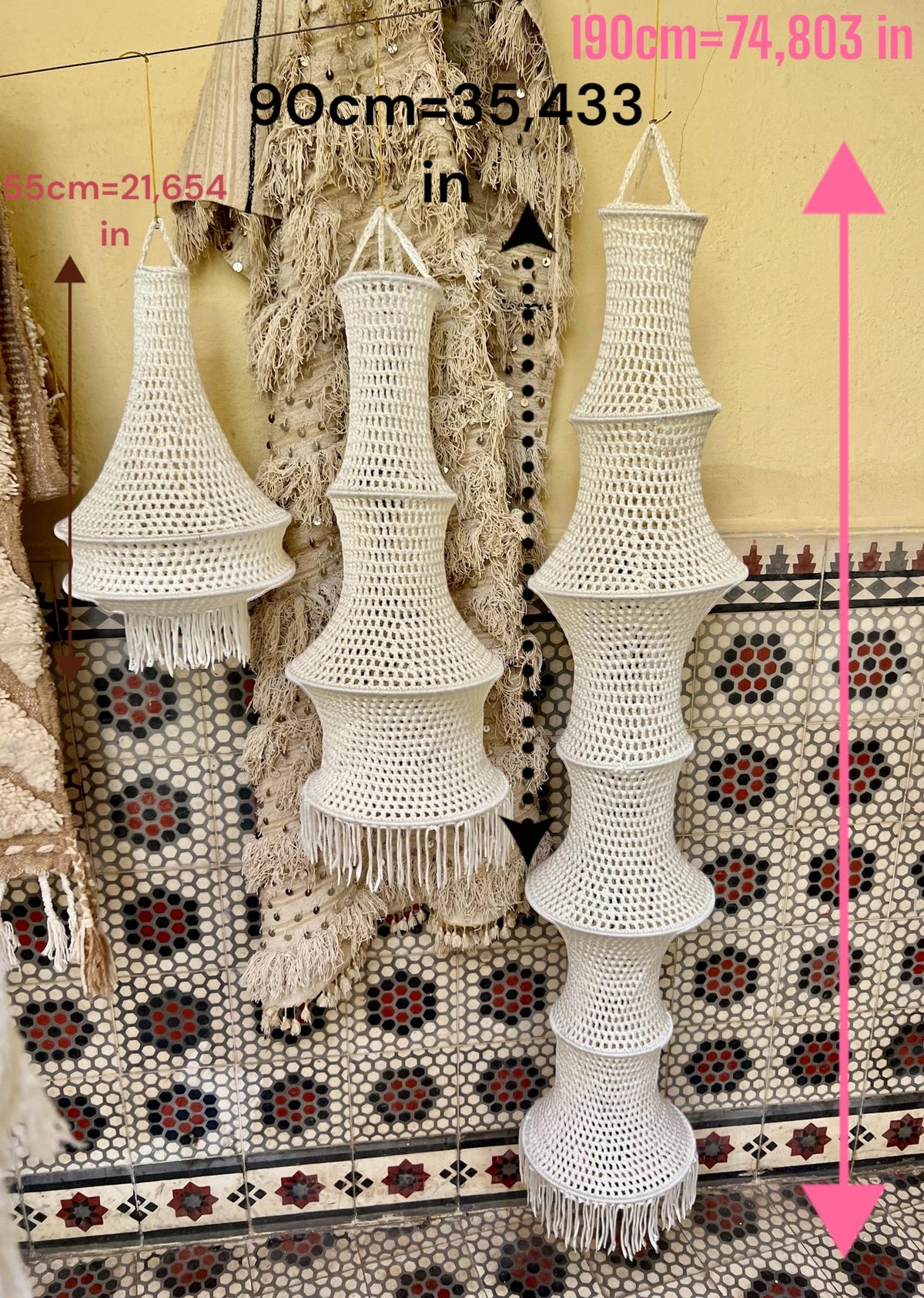 Three off-white crocheted hanging lampshades with fringe trim. The lampshades measure 55 cm (21.654 inches), 90 cm…