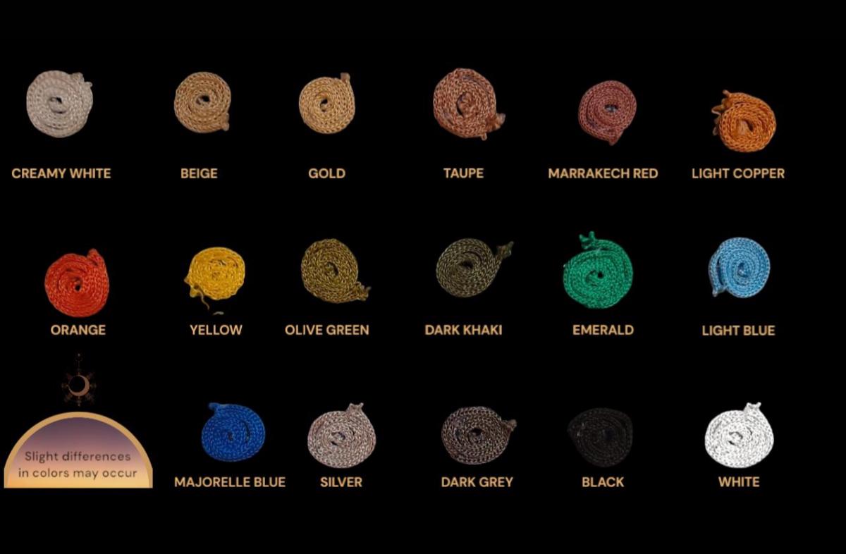 A collection of seventeen coiled cords in various colors including creamy white, beige, gold, taupe, marrakech red, light…