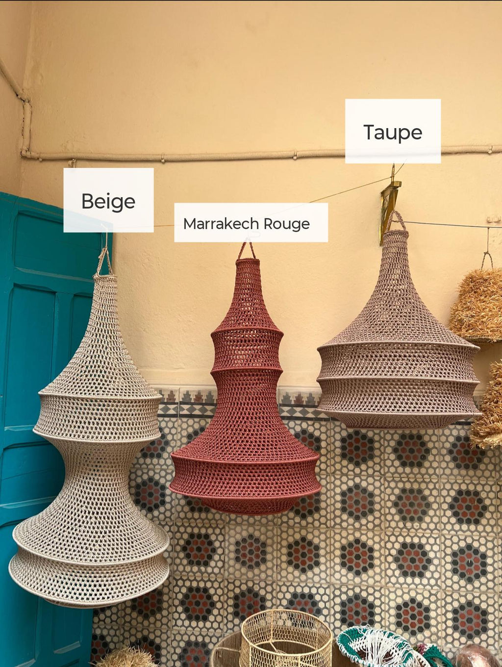 Three hanging pendant lamps with a woven, open-grid texture. The lamps are labeled Beige, Marrakech Rouge, and Taupe.…