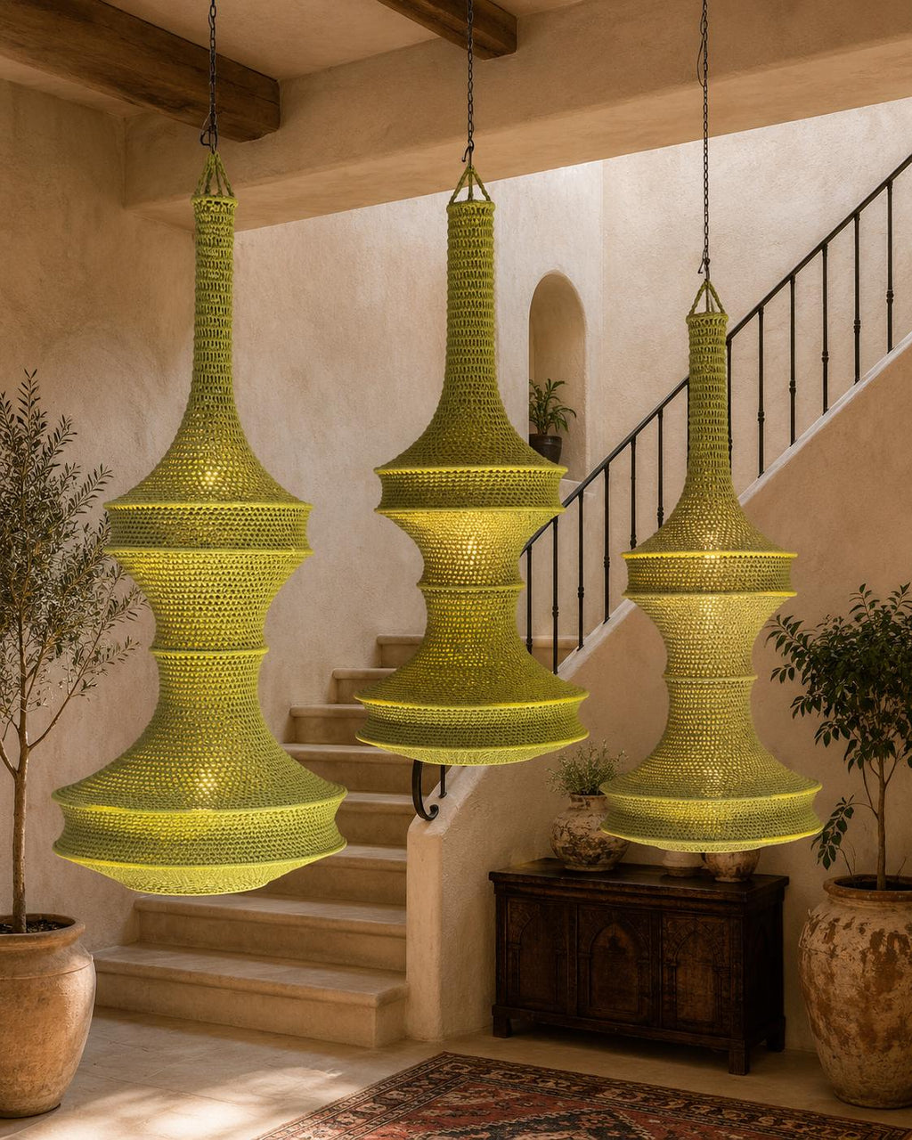 Three lime green pendant lights featuring a tall, slender neck and a wide, tiered base. Each lamp is constructed from a…