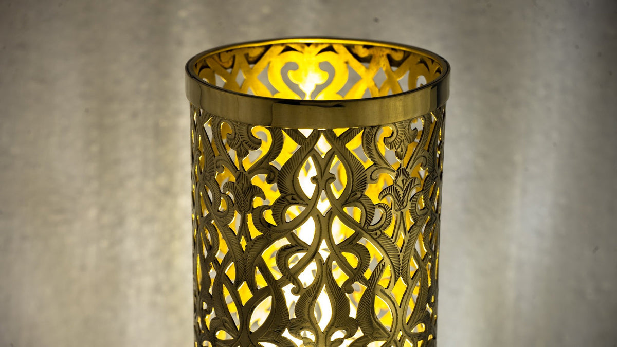 Detail of the lit brass shade casting soft patterned light