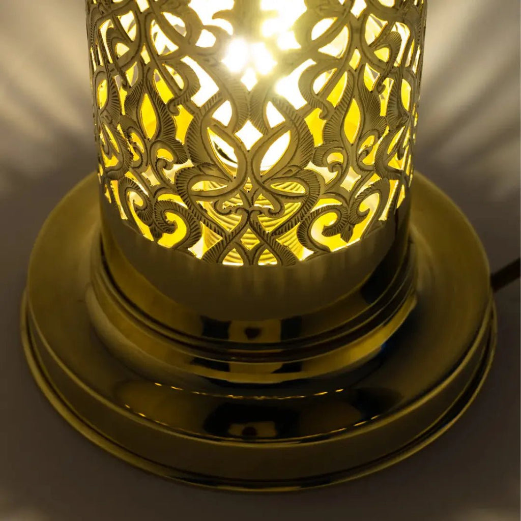Close-up of the illuminated pierced brass shade and stepped base